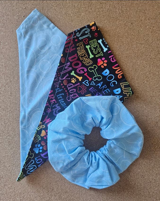 Light blue fabric scrunchie displayed with matching light blue and dog-themed patterned bandanas.